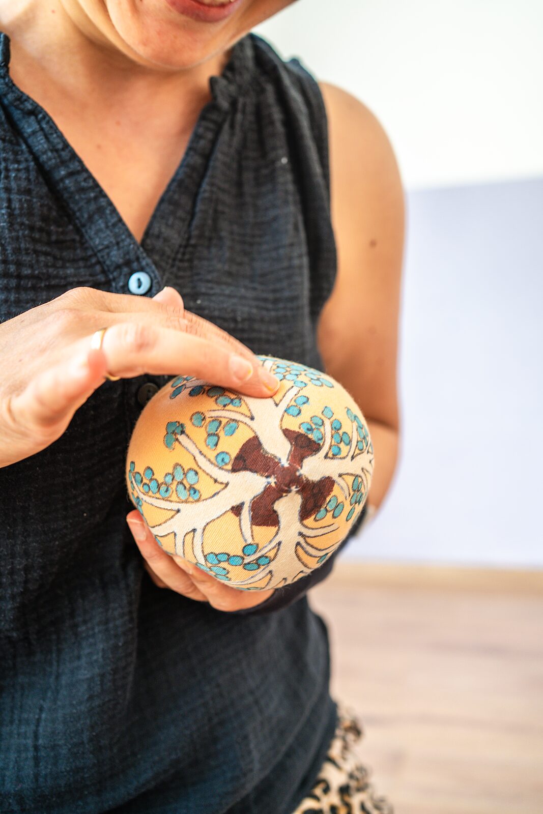 Hebamme hält ein textiles Brustmodell in der Hand
